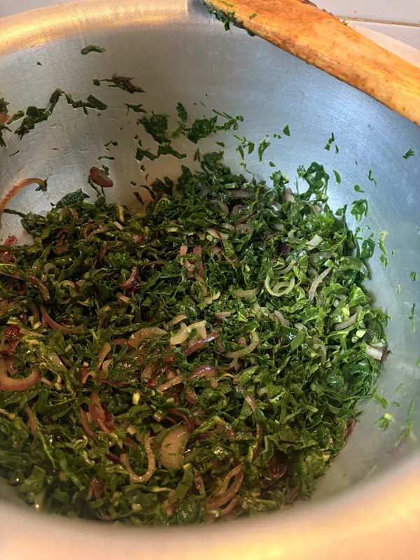 Fresh kachumbari and greens in a mixing bowl